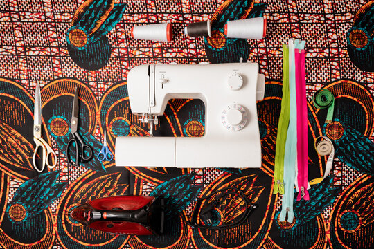 Sewing machine with tools on colorful African fabric