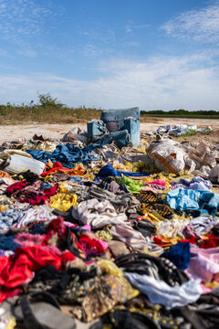 Textile waste polluting a vast open landfill in Senegal