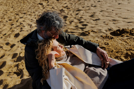 Mature couple embracing enjoying an affectionate moment on beach