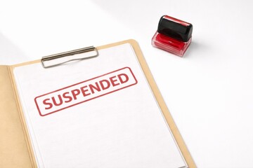 Suspended stamp on document with red ink pad on white background © dvoevnore