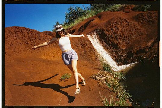 Woman Walking on Red Landscape waterfall