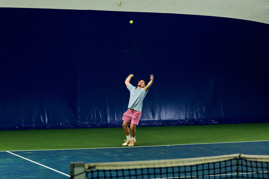 Man serves from the baseline