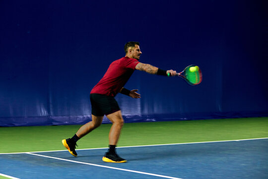 Man hits the tennis ball