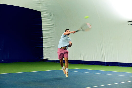 Man hits the tennis ball