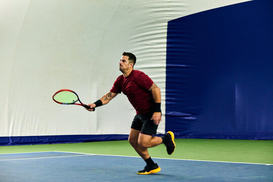 Man engaged in a tennis practice session