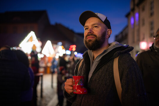Man Holds Cup at Night Market During cold days