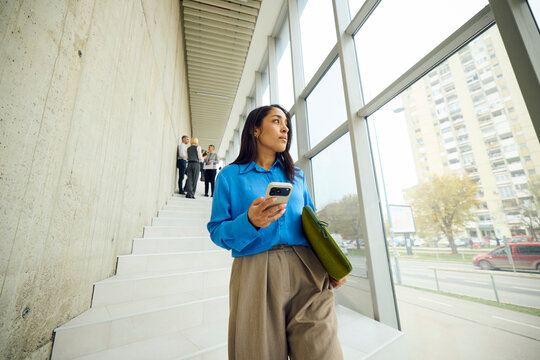 Busy woman climbs down the stairs 