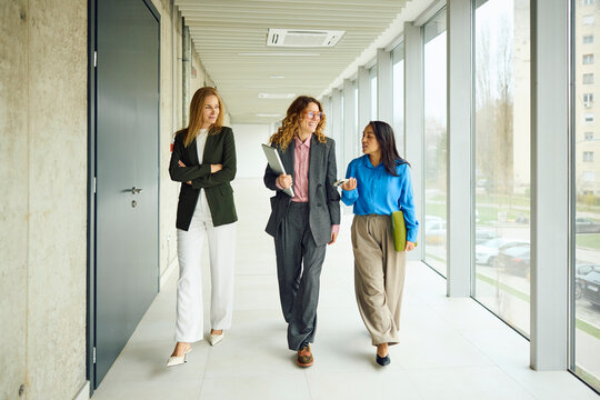 Businesswomen walk through the hallway 