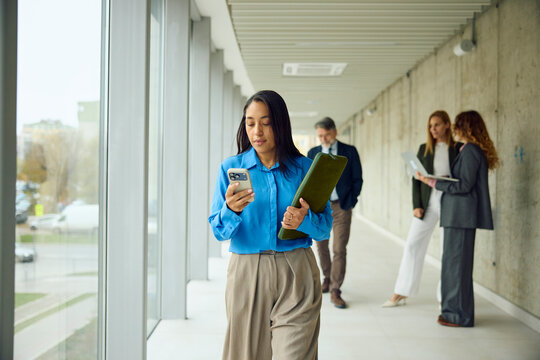 Busy woman moves through the corporate hallway