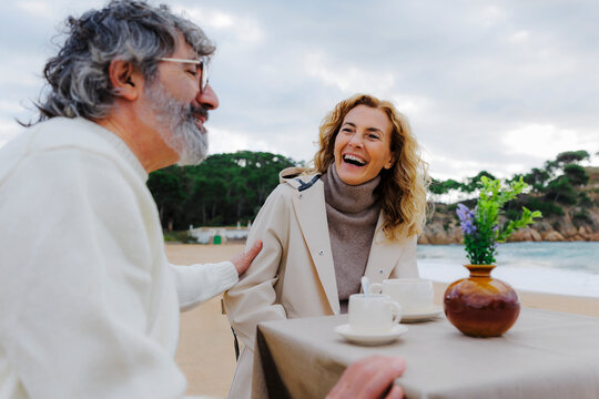 Couple enjoying beachside coffee date