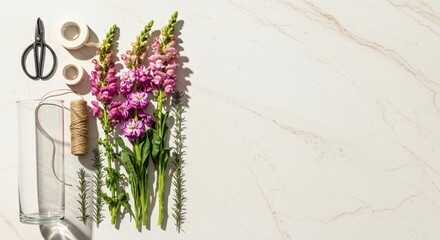 Obraz premium floral arrangement with pink flowers and craft materials on white marble surface