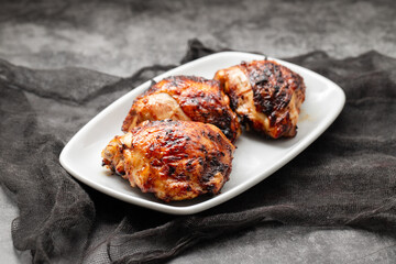 delicious grilled chicken thigh on plate © Natalia Mylova
