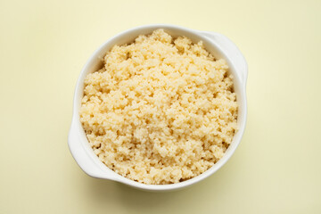 Boiled wheat couscous grain garnish in bowl