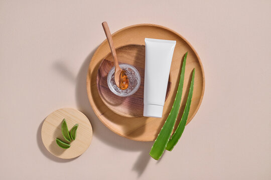 An arrangement of natural beauty elements with a blank cosmetic tube