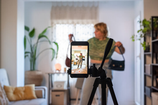 Woman recording vlog on smartphone 