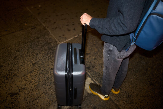 Anonymous traveler with suitcase