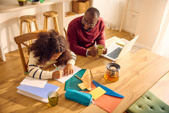 Dad supports his daughter doing her homework