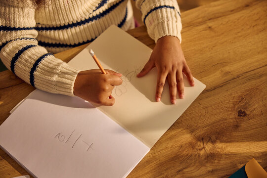 Child sketches in a book