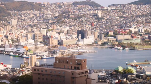 Nagasaki sunset panorama, Inasa mount, Japan, aerial view, city spring skyline, port and mountains, seen from Inasayama park, Nagasaki prefecture, Kyushu island region, ropeway cable car
