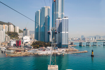 Busan Air Cruise, Busan cable car, ride on multicoloured sky capsule gondola route, with Songdo beach and Skywalk and Busan Bay panorama, South Korea, Songdo Station in a spring sunny day © tsuguliev