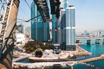 Busan Air Cruise, Busan cable car, ride on multicoloured sky capsule gondola route, with Songdo beach and Skywalk and Busan Bay panorama, South Korea, Songdo Station in a spring sunny day © tsuguliev