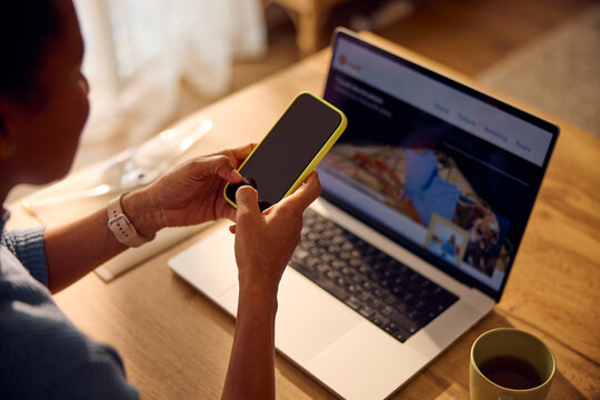 Woman works from home, using technical devices