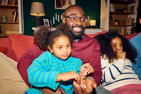 Family enjoys time together watching TV.