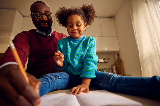 Father and daughter sktech together at home