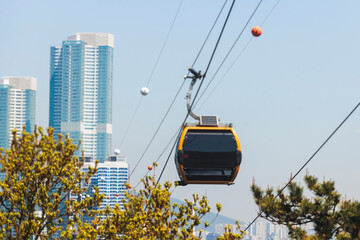 Busan Air Cruise, Busan cable car, ride on multicoloured sky capsule gondola route, with Songdo beach and Skywalk and Busan Bay panorama, South Korea, Songdo Station in a spring sunny day © tsuguliev