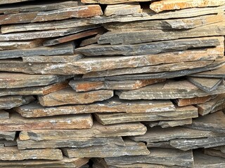 Stacked stone wall creates natural texture and pattern for background use in various designs © dvoevnore