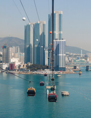 Busan Air Cruise, Busan cable car, ride on multicoloured sky capsule gondola route, with Songdo beach and Skywalk and Busan Bay panorama, South Korea, Songdo Station in a spring sunny day © tsuguliev