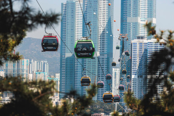 Busan Air Cruise, Busan cable car, ride on multicoloured sky capsule gondola route, with Songdo beach and Skywalk and Busan Bay panorama, South Korea, Songdo Station in a spring sunny day © tsuguliev