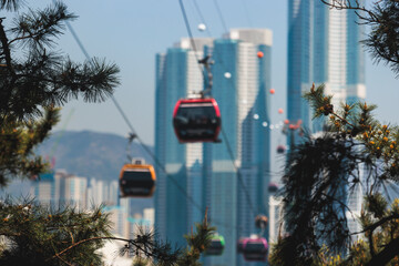 Busan Air Cruise, Busan cable car, ride on multicoloured sky capsule gondola route, with Songdo beach and Skywalk and Busan Bay panorama, South Korea, Songdo Station in a spring sunny day © tsuguliev