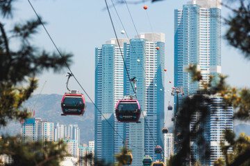 Busan Air Cruise, Busan cable car, ride on multicoloured sky capsule gondola route, with Songdo beach and Skywalk and Busan Bay panorama, South Korea, Songdo Station in a spring sunny day © tsuguliev