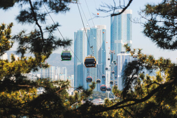 Busan Air Cruise, Busan cable car, ride on multicoloured sky capsule gondola route, with Songdo beach and Skywalk and Busan Bay panorama, South Korea, Songdo Station in a spring sunny day © tsuguliev