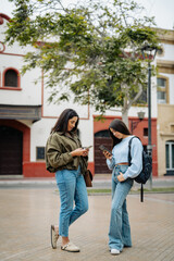 Obraz premium Young women using smartphones for social media connection