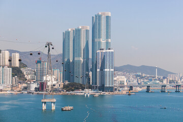 Busan Air Cruise, Busan cable car, ride on multicoloured sky capsule gondola route, with Songdo beach and Skywalk and Busan Bay panorama, South Korea, Songdo Station in a spring sunny day © tsuguliev
