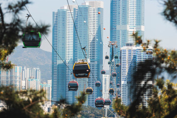 Busan Air Cruise, Busan cable car, ride on multicoloured sky capsule gondola route, with Songdo beach and Skywalk and Busan Bay panorama, South Korea, Songdo Station in a spring sunny day © tsuguliev