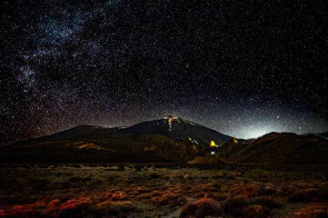 Stars gazing at night on Tenerife, mount Teide vulcano national park night excursion, astronomy educational tour, tourists destination, scenic view on mountains and stars on dark sky © barmalini
