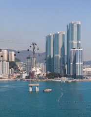 Busan Air Cruise, Busan cable car, ride on multicoloured sky capsule gondola route, with Songdo beach and Skywalk and Busan Bay panorama, South Korea, Songdo Station in a spring sunny day © tsuguliev