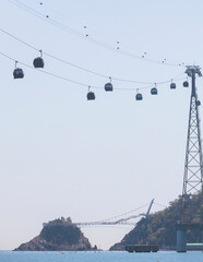 Busan Air Cruise, Busan cable car, ride on multicoloured sky capsule gondola route, with Songdo beach and Skywalk and Busan Bay panorama, South Korea, Songdo Station in a spring sunny day © tsuguliev