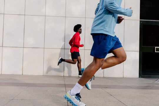 Runners train in front of a building in Madrid&rsquo;s financial district