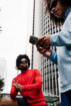 Men checking fitness data on their smartphones while resting