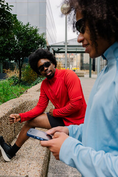 Sportsmen checking performance data on their smartphones