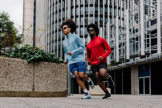 Young men jogging through Madrid's business district