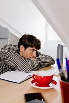 Freelance professional staring at a computer with a tired gaze