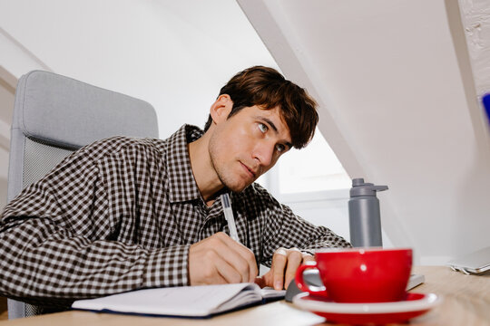 Office professional taking handwritten notes in a notebook