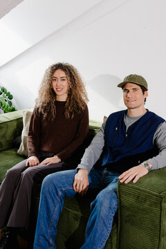 Self-employed couple acing the camera with cheerful smiles