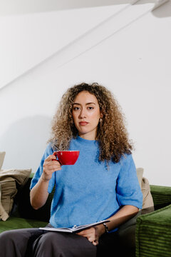 Medium shot portrait of a freelance woman looking directly at camera