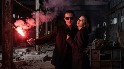 Caucasian man protector and woman standing together holding red flare in dark abandoned industrial building, relationship responsibility and male security concept banner with copy space